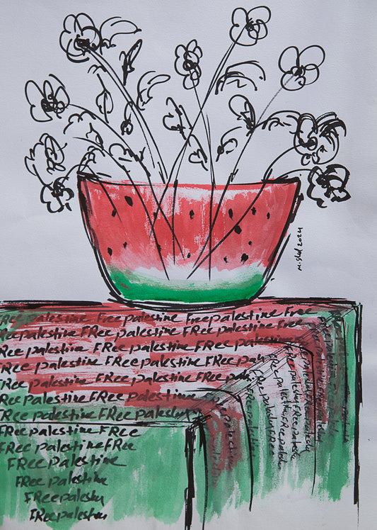 a watermelon vase filled with flowers sitting on a table with a table cloth imprinted with Free Palestine in red, green and black. Political palestinian art by Muftah Elsheref