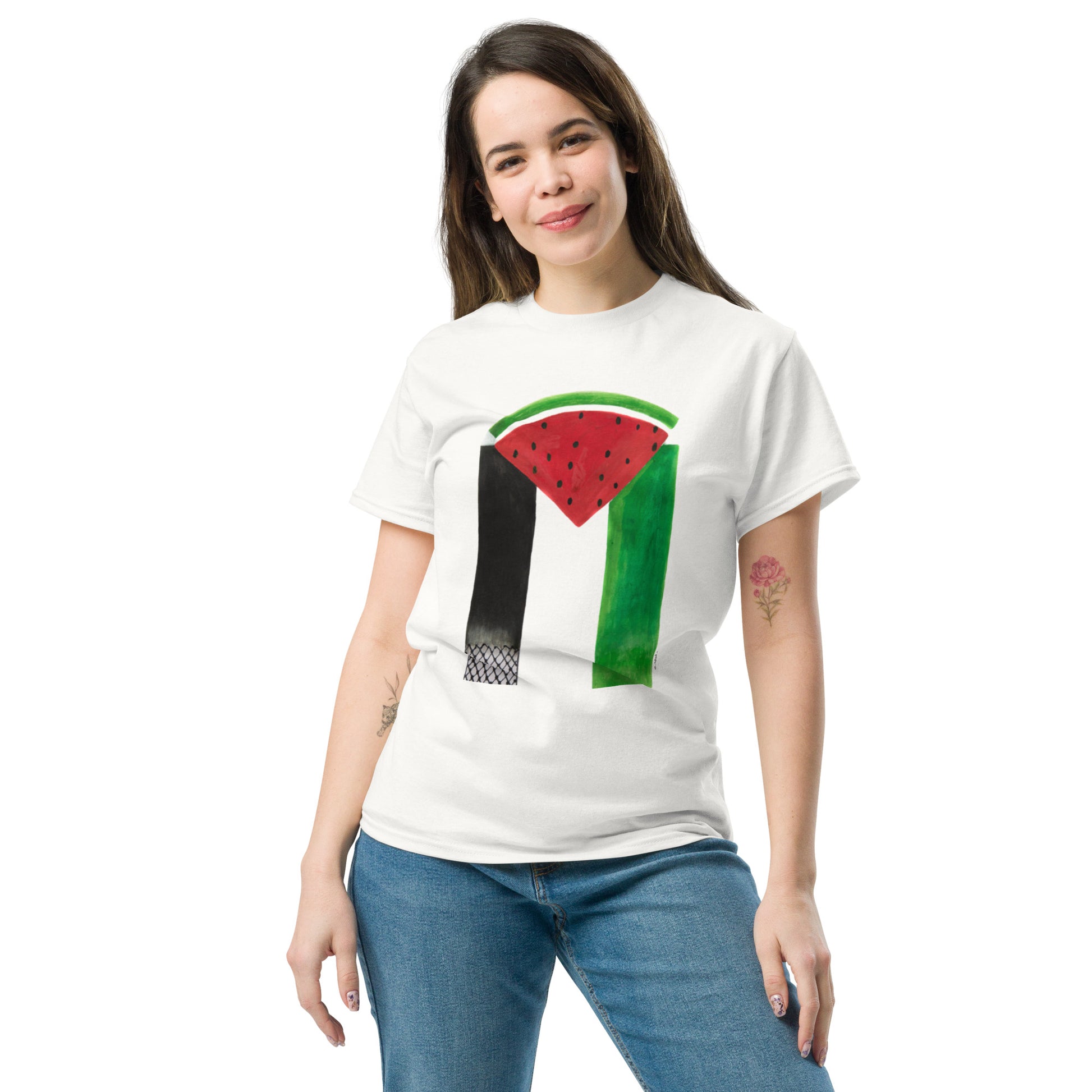 Woman wearing white t-shirt with Muftah Elsheref’s “Free Palestine” design featuring a watermelon slice and stylized Palestinian flag colors